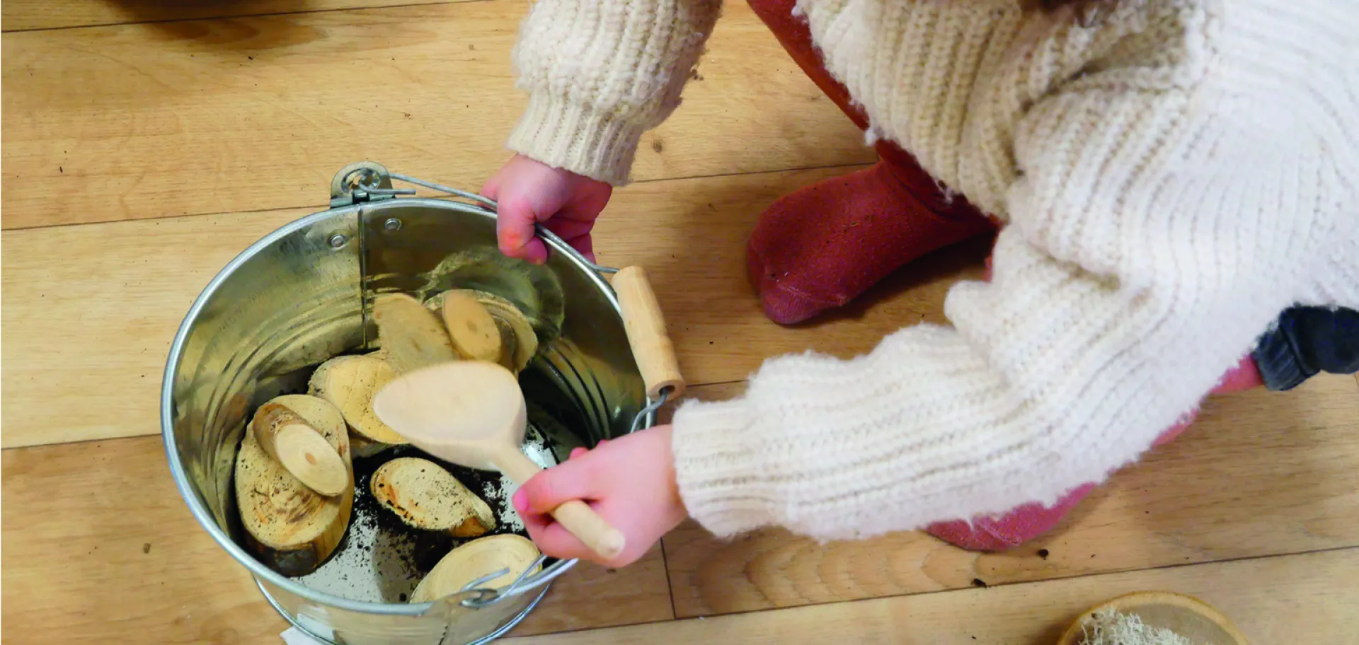 enfant mélangeant un plat de végétaux avec une cuillère 