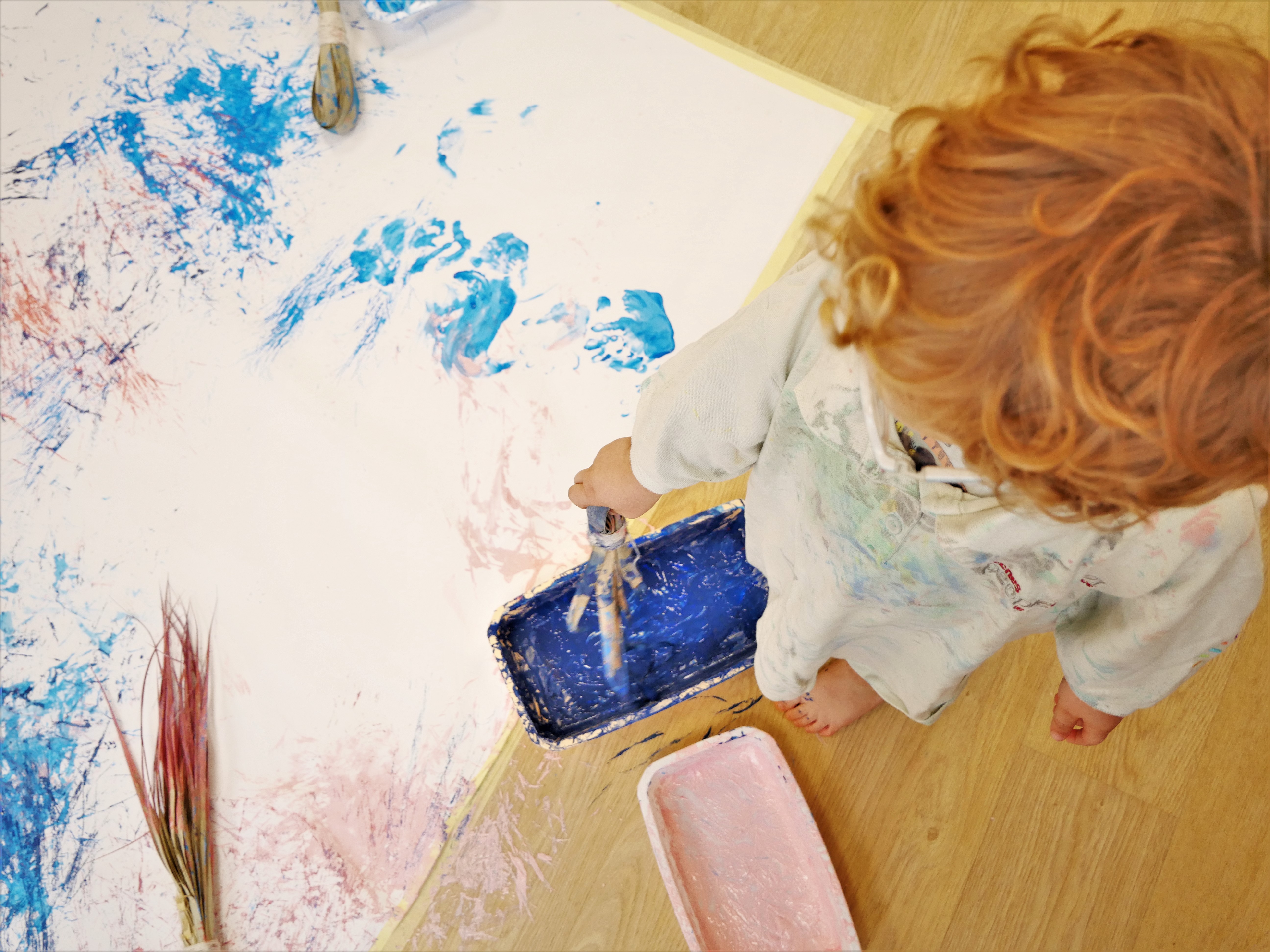 enfant tenant une branche de palmier avec peinture
